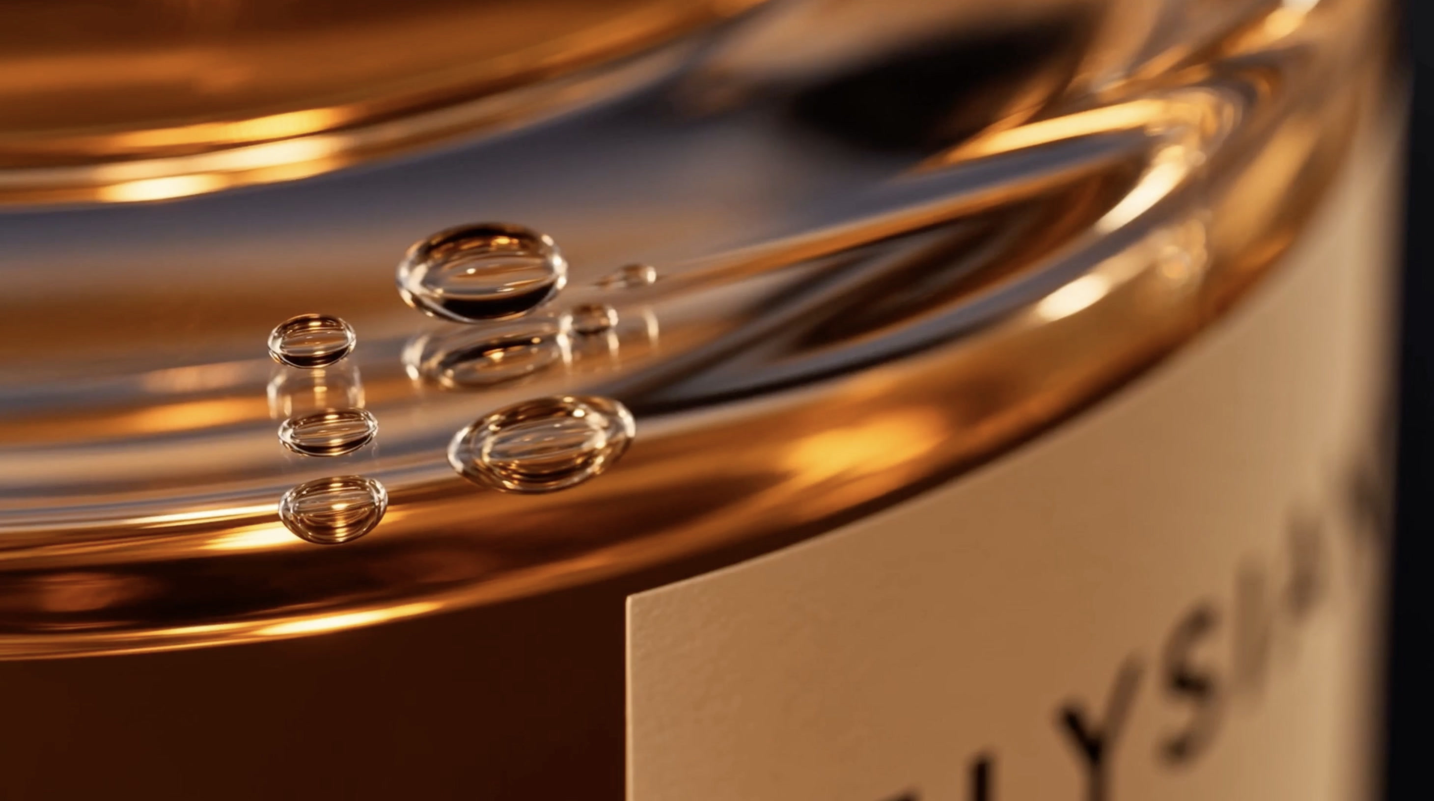 Droplets beaded on the amber shoulder of the bottle, the label edge in close focus